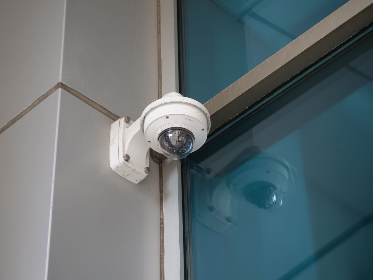 Surveillance camera mounted on a modern commercial building